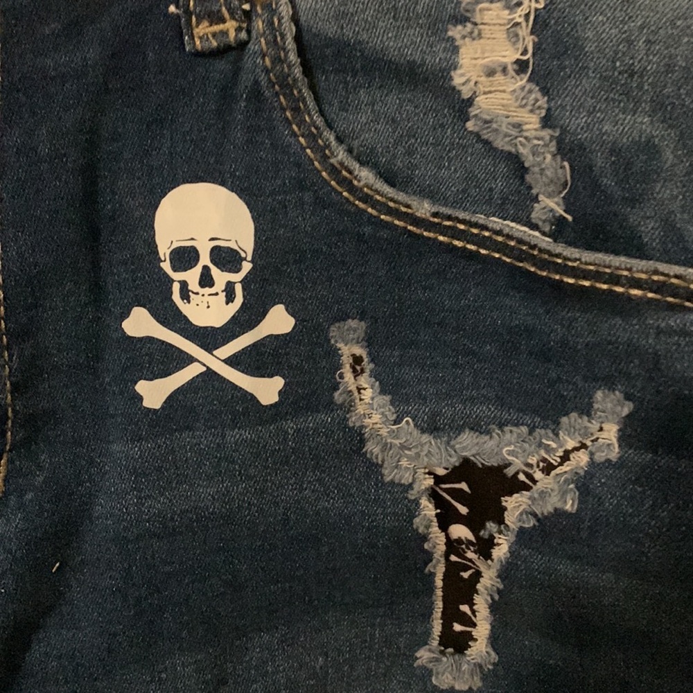 Shorts size small, skull front & back. Has tears but cloth under holes